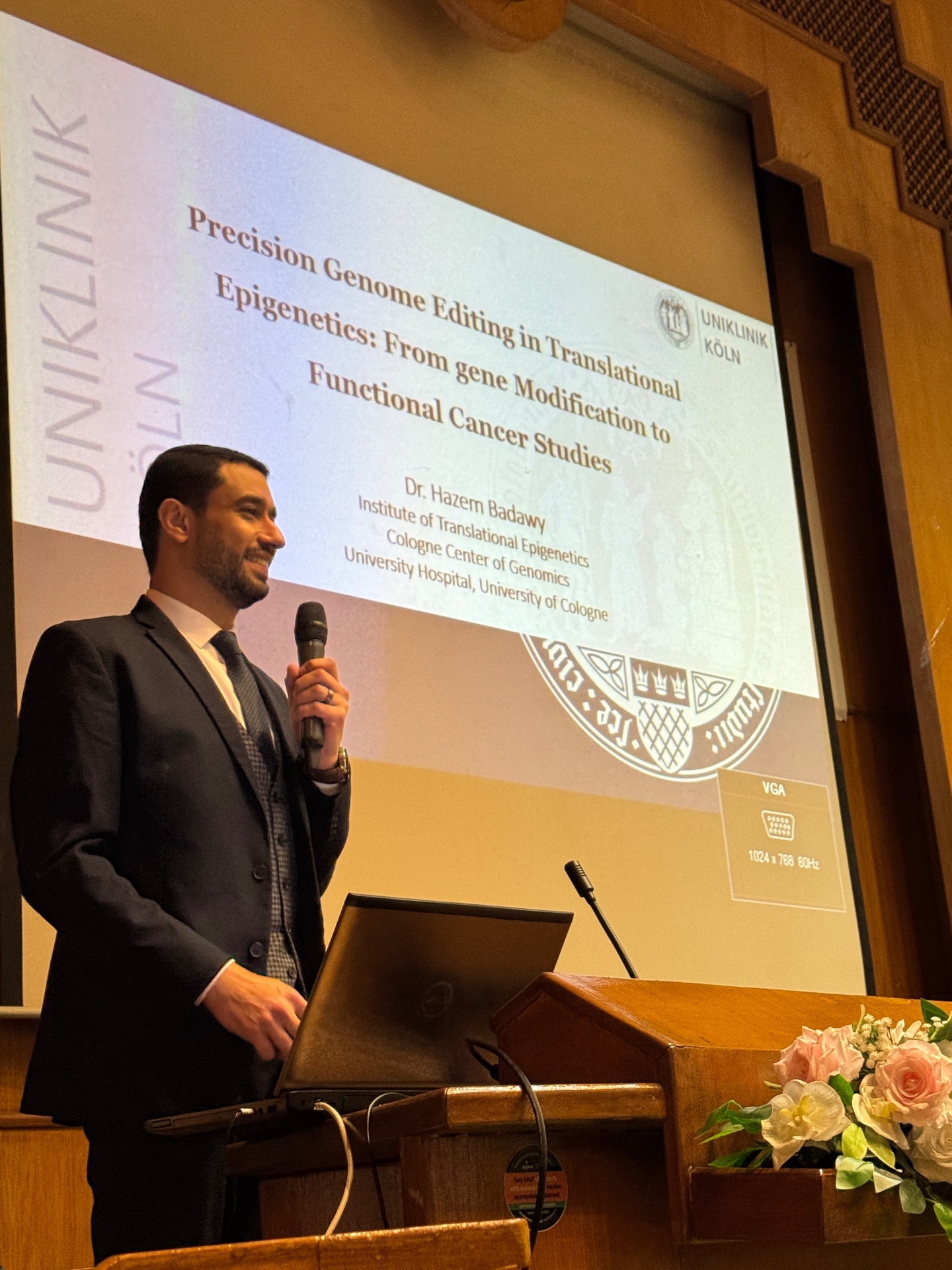 Speaker presenting precision genome editing and epigenetics research at the event